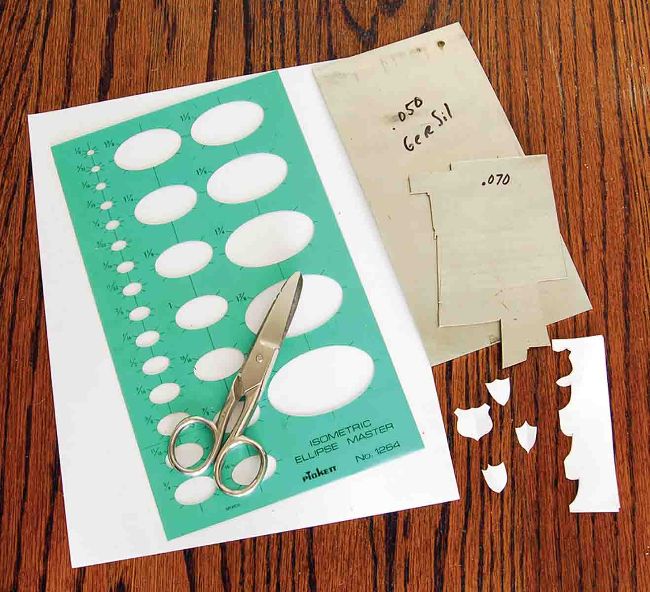 Initial shields can be drawn on paper and cut out or traced using an ellipse template.